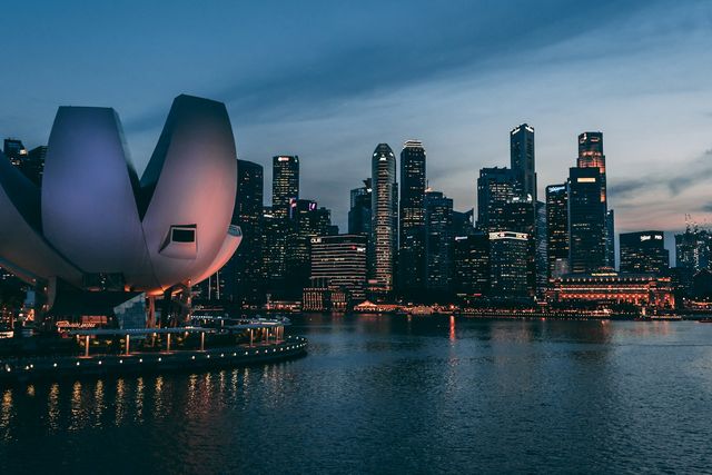 ArtScience Museum and the skyline of Singapore’s financial district at dusk